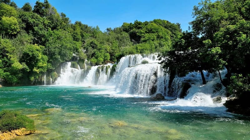 From Split: Krka Waterfalls with Riverboat Ride & swimm stop - Getting there with an air-conditioned coach, and why timing matters