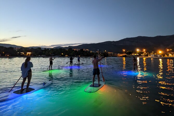 Guided Transparent SUP Glow Tour in Split - Getting on a transparent SUP before the glow starts